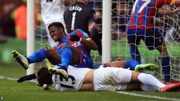 Wilfried Zaha collides with the post after Crystal Palace's opener against QPR