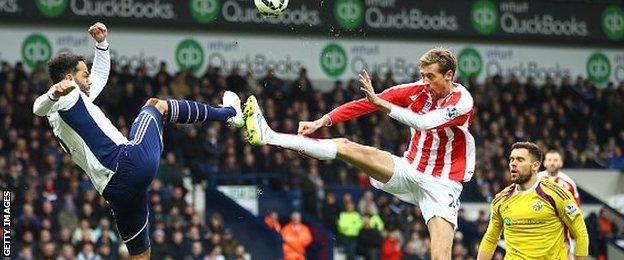 Joleon Lescott charges down Peter Crouch's header