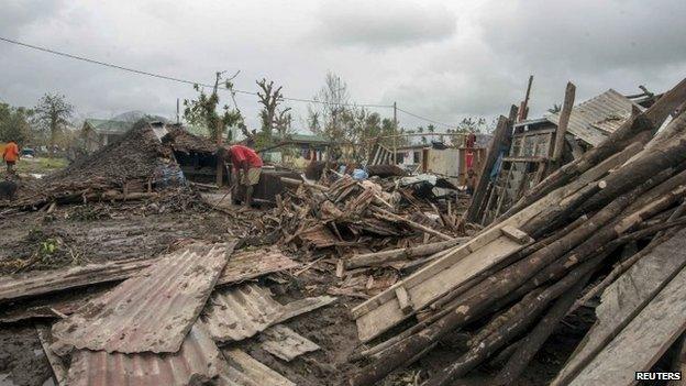 Local residents move debris near their homes destroyed by Cyclone Pam in Port Vila, the capital city of the Pacific island nation of Vanuatu, on Sunday