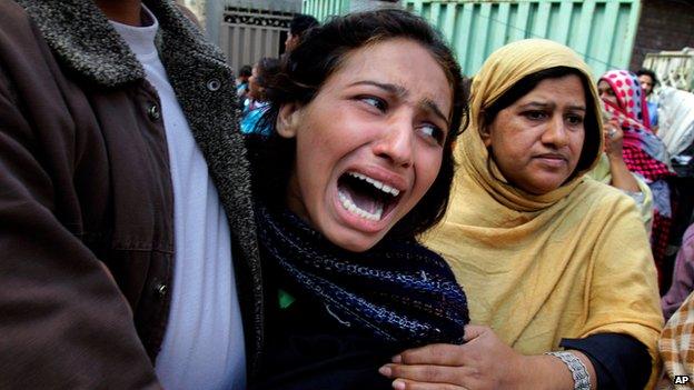 A woman mourns a family member killed in a suicide bombing