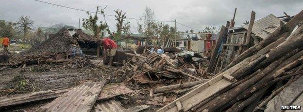 Man clears debris in Port Vila, Vanuatu (15 March 2015)