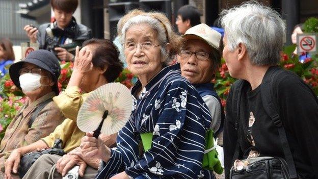 Elderly residents rest in the grounds of a temple in Tokyo on September 15, 2014 as the country marks Respect-for-the-Aged-Day.