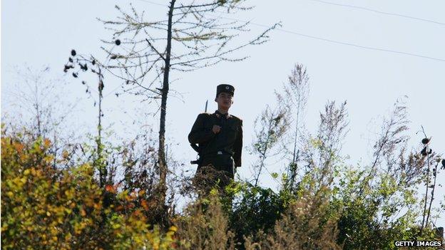 A North Korean soldier guards the border with China