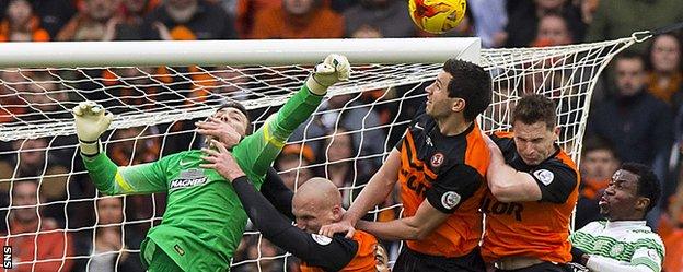 Craig Gordon is challenged by three Dundee United players at Hampden