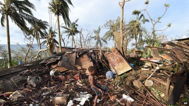 Young boy picks through the debris in Port Vila, Vanuatu after Cyclone Pam - Monday, March 16, 2015