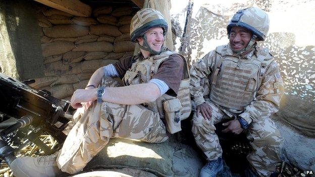 Prince Harry talks to a Gurkha soldier at the observation post at JTAC Hill in Helmand province