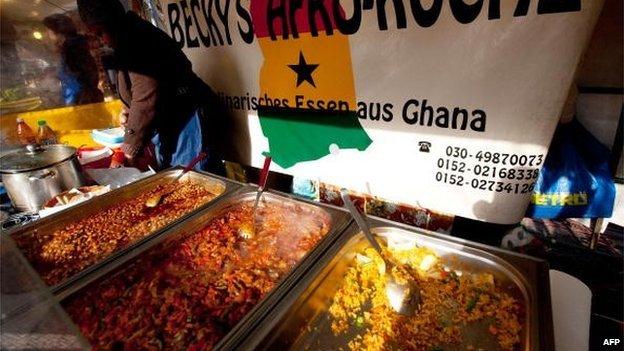 A woman sells food from Ghana at a market on the Maybachufer in Berlin's Neukoelln district on March 9, 2010