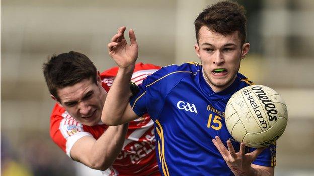 Cavan's Thomas Edward Donohue attempts to burst away from Dungannon's Conal Lyons in the MacRory Cup decider