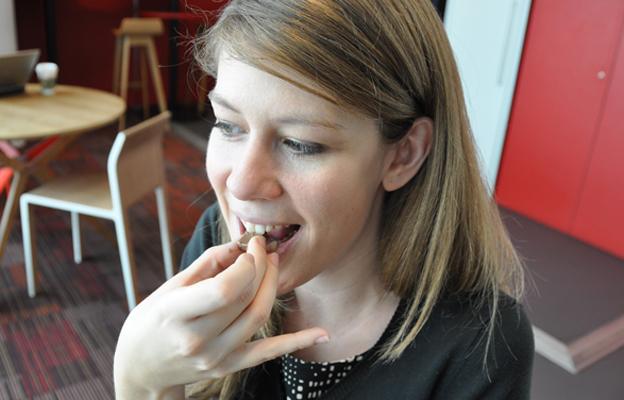 Sarah Geisman takes a bite of a piece of chocolate