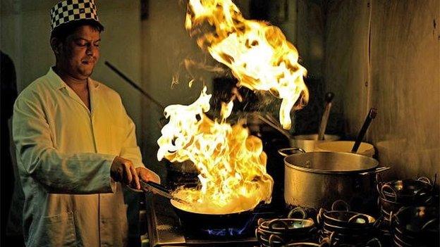 Saiful Islam, a chef in an Indian restaurant on Brick Lane in east London, is pictured at work on 23 September 2009