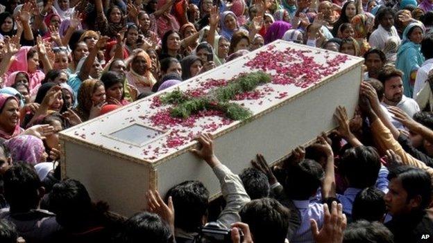 Pakistani Christians carry a casket of a victim of Sunday"s pair of suicide attacks on two churches during a mass funeral service in Lahore, Pakistan