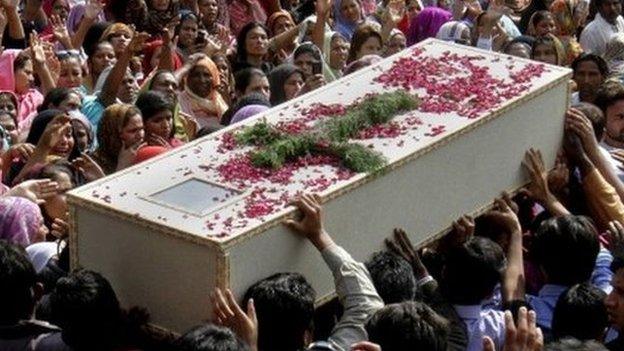 Pakistani Christians carry a casket of a victim of Sunday"s pair of suicide attacks on two churches during a mass funeral service in Lahore, Pakistan