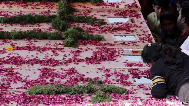 Coffins for some of the victims of Sunday's suicide bombings in Lahore