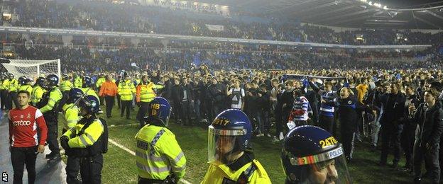 Reading fans invade the pitch at full time at the Madejski Stadium