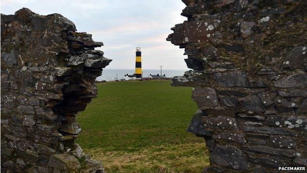 View of the lighthouse at St John's Point from ruins of nearby building