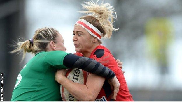 Adi Taviner of Wales is tackled by Niamh Briggs in Swansea