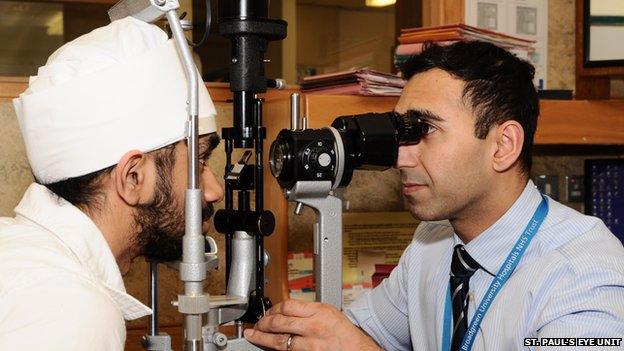 Surgeon Sajjad Ahmad from St Paul's Eye Unit with a patient