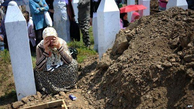 A Bosnian Muslim woman cries during a mass burial for 775 newly identified victims of the 1995 Srebrenica massacre at the Srebrenica Memorial Cemetery in Potocari, Bosnia and Herzegovina (11 July 2010)