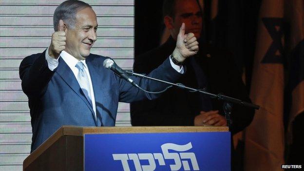 Israeli Prime Minister Benjamin Netanyahu gestures to supporters at party headquarters in Tel Aviv