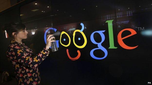 A customers tries the digital spray wall at the new Google store