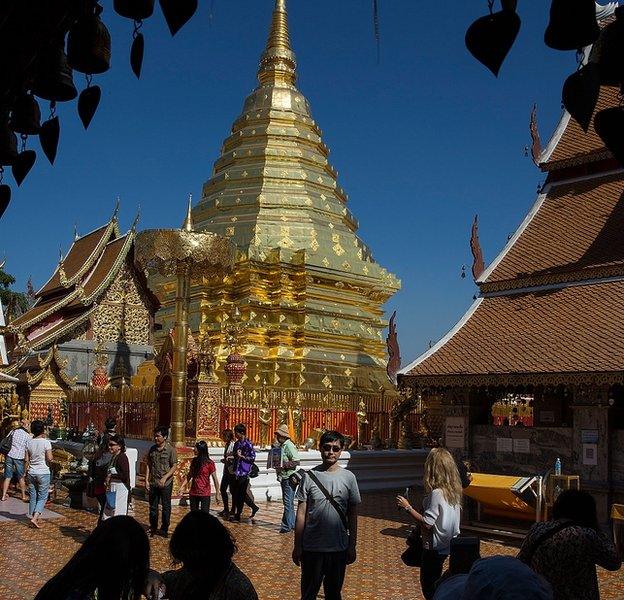 A traveller poses for a picture at Wat Doi Suthep temple in Chiang Mai, where Chinese tourists have been accused of bad behaviour