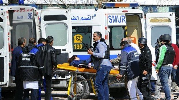 A victim is evacuated by rescue workers outside the Bardo museum in Tunis, 18 March 2015