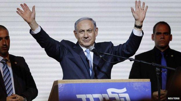 Israeli Prime Minister Benjamin Netanyahu waves to supporters at the party headquarters in Tel Aviv March 18, 2015