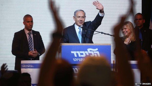 Israeli Prime Minister Benjamin Netanyahu (C) delivers a speech next to his wife Sara as he reacts to exit poll figures in Israel"s parliamentary elections late 17 March 2015