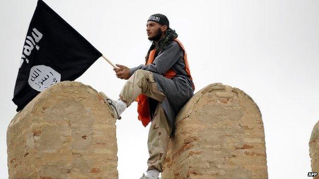 A Tunisian Islamist waves a Salafist flag reading: "There is only one God" during a rally in May 2012 in Tunisia for the Ansar al-Sharia's national congress