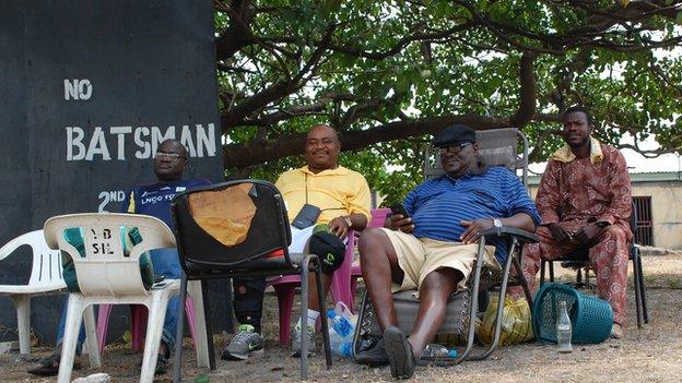 Cricket spectators - including former Nigerian internationals - watching a game of cricket in Lagos, Nigeria