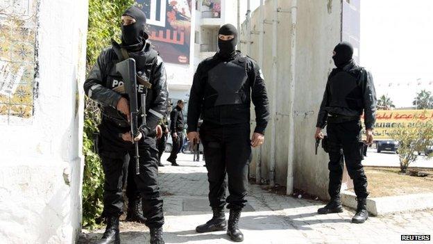 Police officers stand outside the parliament in Tunis, 18 March 2015