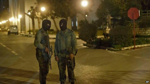 Masked Tunisian soldiers stand guard at the museum