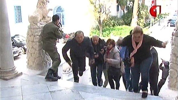 Screengrab from National Tunisian TV showing hostages fleeing outside parliament