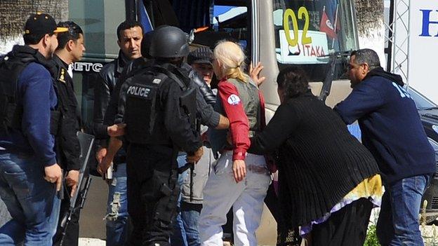 A survivor of the museum attack getting on a bus