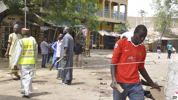 People gathered at the site of a suicide bomb explosion at a market in Maiduguri