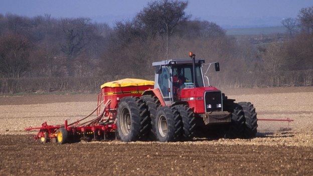 Tractor sowing a field