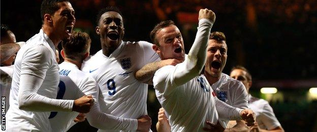 Wayne Rooney of England celebrates after scoring his team's second goal during the friendly with Scotland