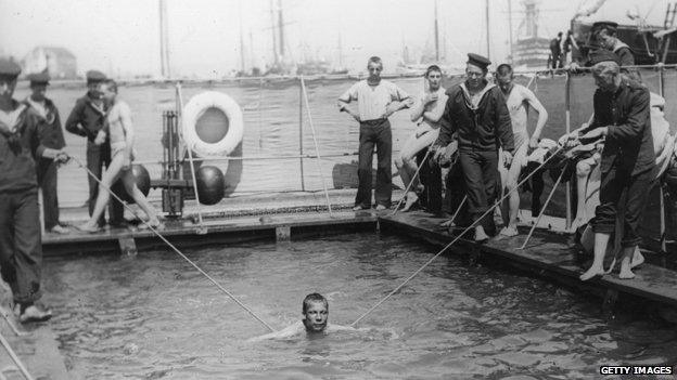 1910: Naval cadets receiving swimming lessons