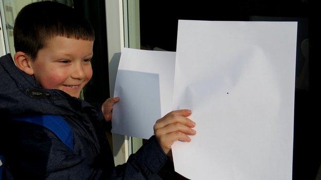 Boy with eclipse viewer