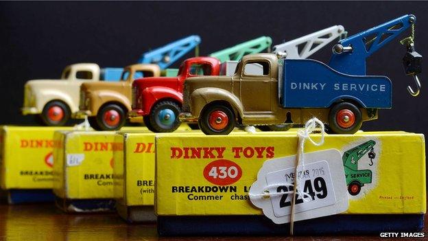 Row of Dinky trucks sitting on top of their original boxes