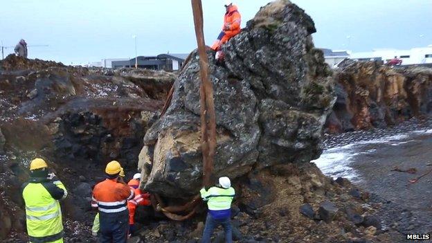 A crane is used to move a rock in Iceland thought to be an elf church to make way for a new road on 18 March 2015