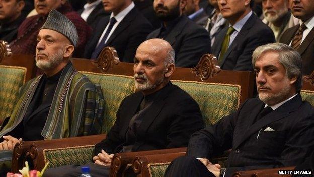Afghan President Ashraf Ghani (C), Chief Executive Officer Abdullah Abdullah (R) and former president Hamid Karzai look on during a ceremony to mark the first anniversary of the death of former vice president Mohammad Qasim Fahim at the loya jirga hall in Kabul 9 March 2015