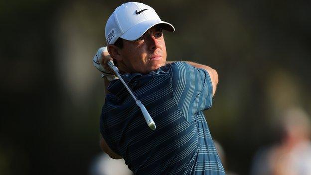 Rory McIlroy hits a tee shot at the 13th hole on Friday