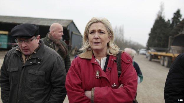 National Front leader Marine Le Pen visits a farm in the French town of Juilley on 20 March 2015