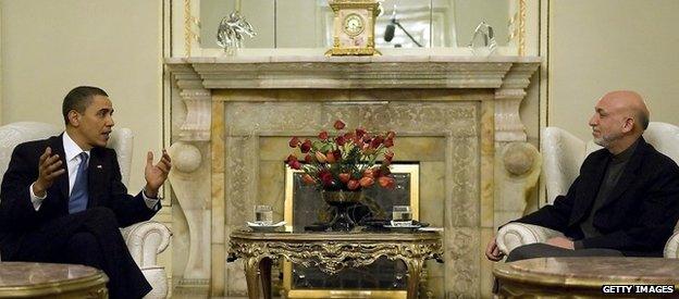 US President Barack Obama (L) speaks with Afghan President Hamid Karzai during a meeting at the Presidential Palace in Kabul 28 March 2010