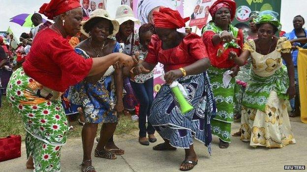 Women dance during a rally by the ruling People's Democratic Party (PDP) in Nigeria's Akwa Ibom state, 14 March 2015