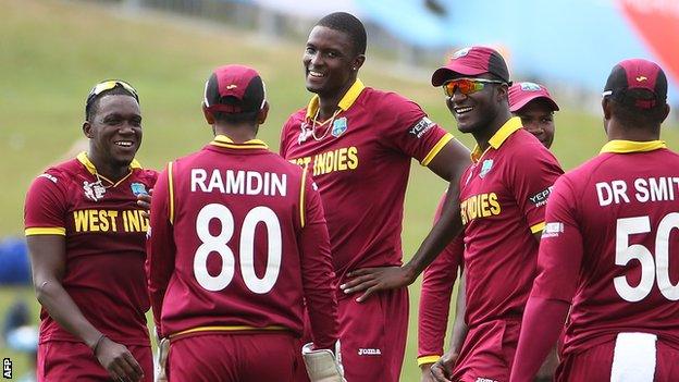 Jason Holder (centre) celebrates a wicket with team-mates