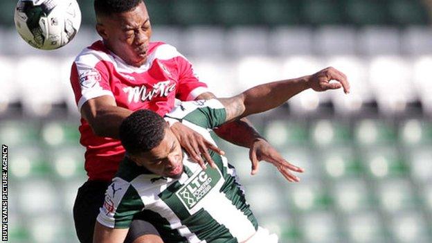 Ryan Jackson of Newport County gets above Tareiq Holmes-Dennis of Plymouth Argyle