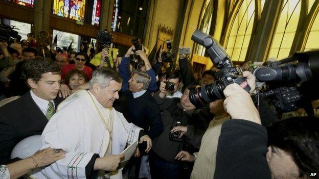 Protesters shout as Rev Juan Barros enter the Osorno cathedral