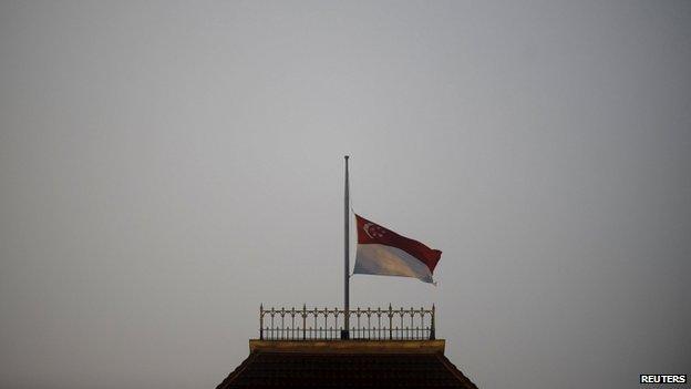 The state flag is pictured at half-mast at the parliament building in Singapore 23 March 2015